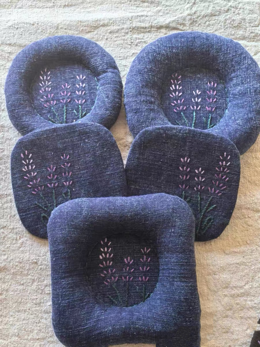 Hand-embroidered plant-dyed linen coasters and trivets